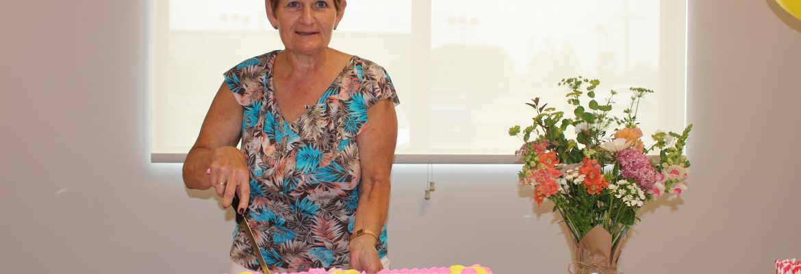 Photo of Rosemary cutting her retirement cake